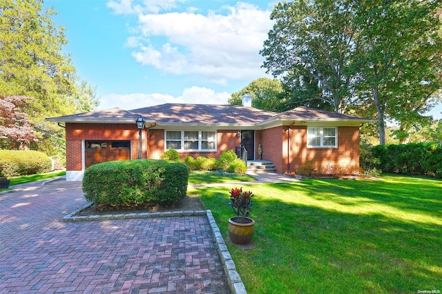 view of front of house with a front yard and a garage