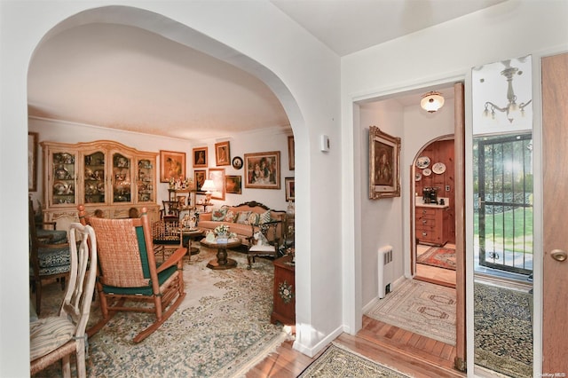 foyer entrance featuring radiator and light hardwood / wood-style floors