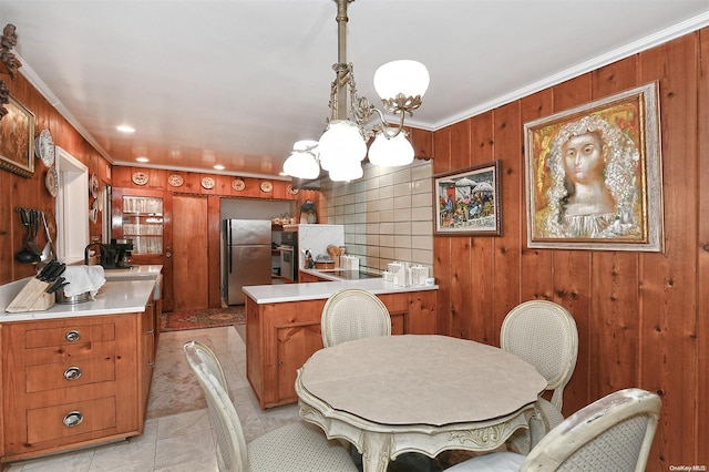 dining room featuring wood walls, ornamental molding, and light tile patterned floors