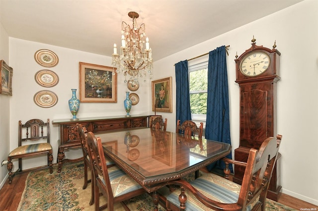 dining room with wood-type flooring and a notable chandelier