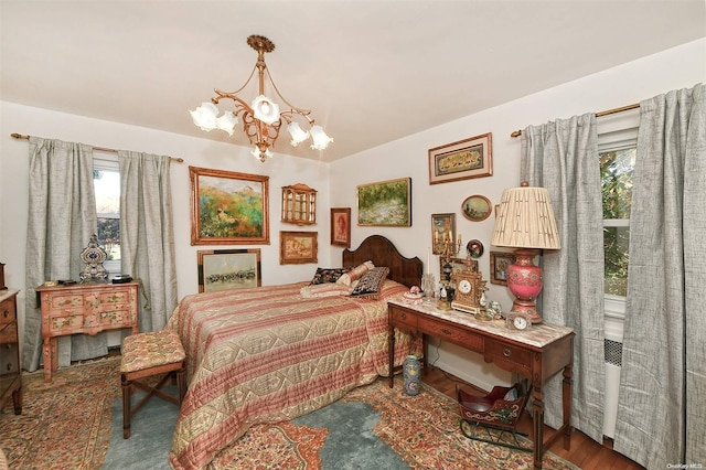 bedroom featuring hardwood / wood-style flooring and a notable chandelier