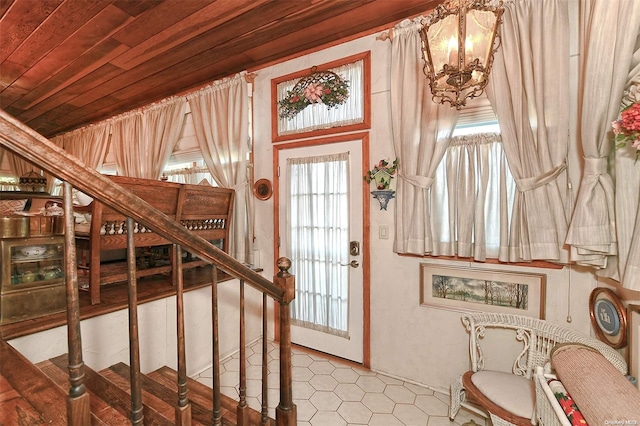 entrance foyer featuring wooden ceiling and a notable chandelier