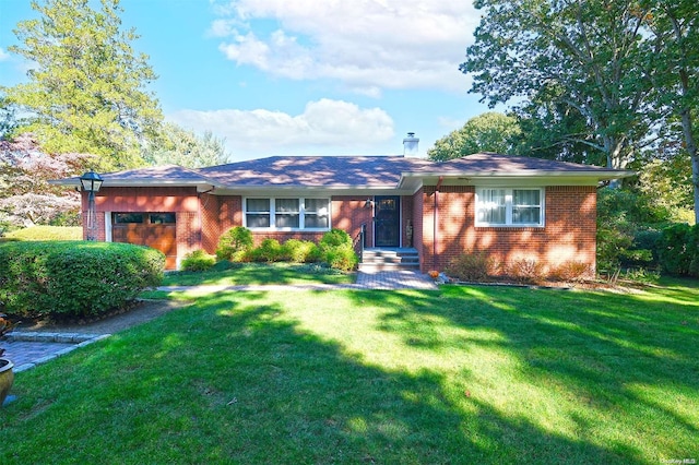 ranch-style house featuring a garage and a front lawn