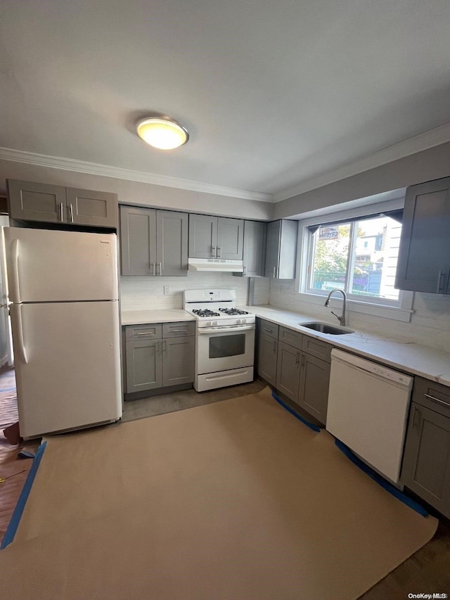 kitchen featuring gray cabinetry, crown molding, sink, and white appliances