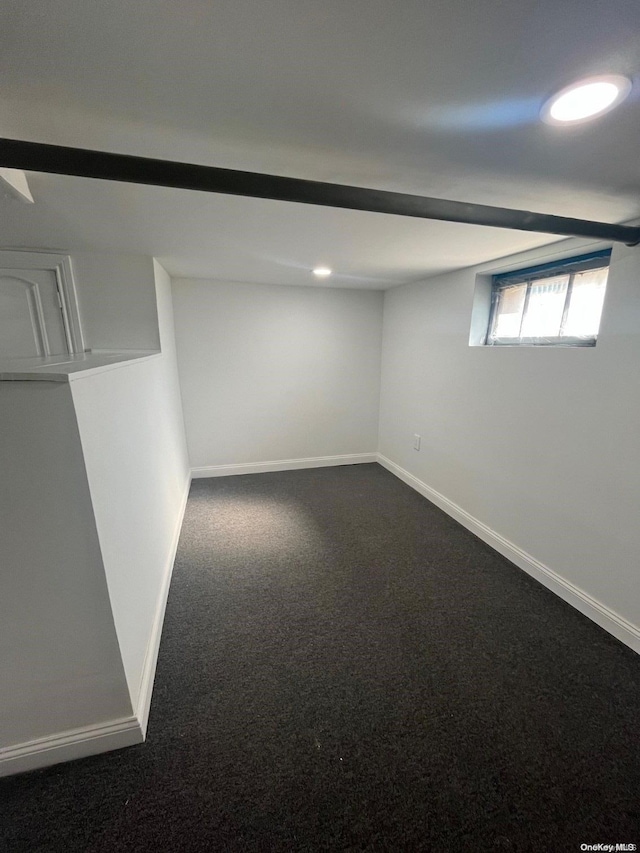 basement featuring dark colored carpet