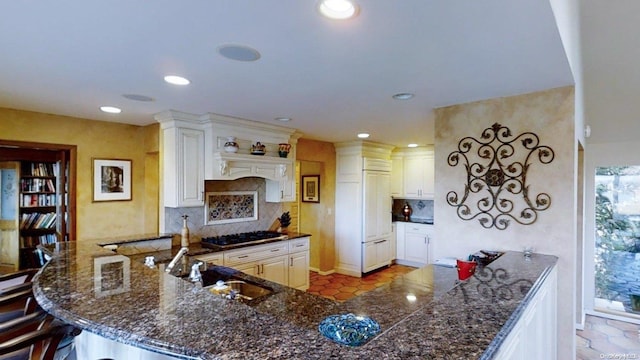 267 Great River Rd, Great River, NY 11739 - kitchen with a sink, stainless steel gas stovetop, backsplash, recessed lighting, and a peninsula
