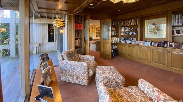 living area with carpet flooring, beamed ceiling, and coffered ceiling