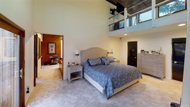 bedroom with light carpet and a high ceiling