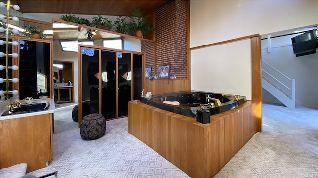 267 Great River Rd, Great River, NY 11739 - bathroom with a garden tub, a sink, and high vaulted ceiling