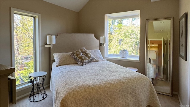 bedroom with light carpet and lofted ceiling