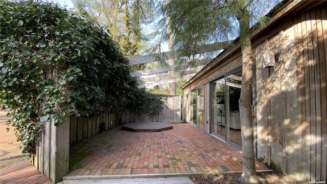 view of patio with a pergola and a hot tub