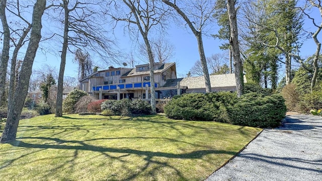 267 Great River Rd, Great River, NY 11739 - view of front of property featuring board and batten siding, a front yard, and a chimney