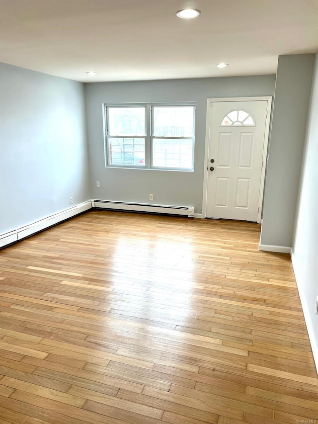 entryway featuring a baseboard radiator and light wood-type flooring