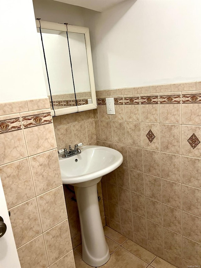 bathroom with tile walls and tile patterned floors