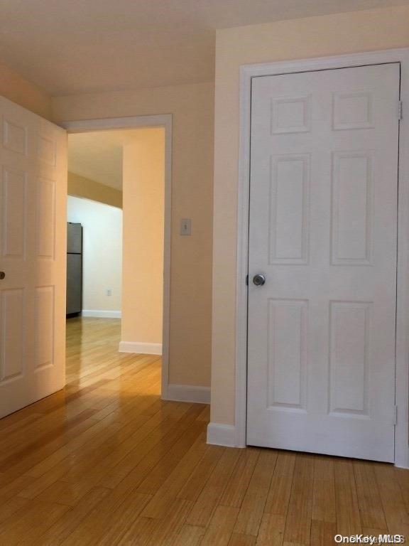 corridor with light wood-type flooring