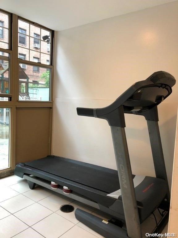 workout area featuring light tile patterned floors