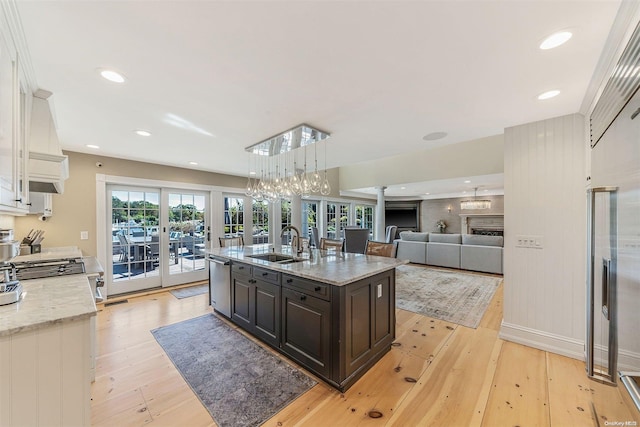 300 Maple St, Islip, NY 11751 - kitchen with a sink, white cabinets, light wood finished floors, decorative columns, and dishwasher