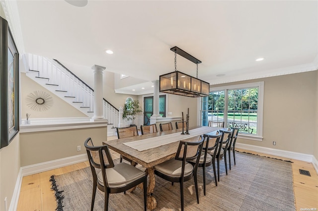 300 Maple St, Islip, NY 11751 - dining area featuring decorative columns, light wood finished floors, baseboards, recessed lighting, and crown molding