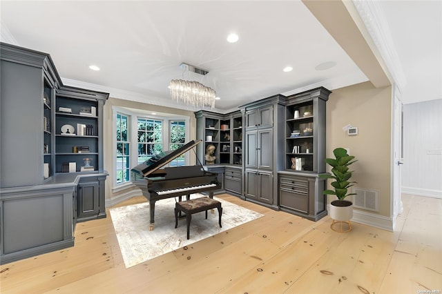 miscellaneous room featuring light wood-type flooring, crown molding, and an inviting chandelier