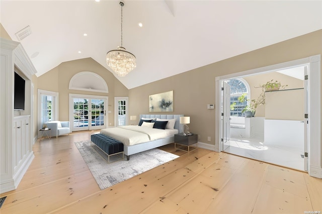 bedroom with access to outside, multiple windows, a chandelier, and light wood-type flooring