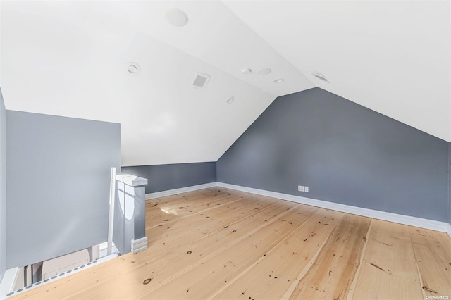 300 Maple St, Islip, NY 11751 - additional living space with lofted ceiling, hardwood / wood-style flooring, and baseboards