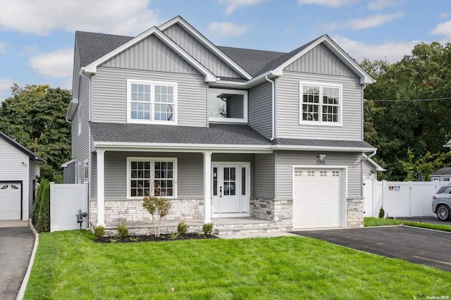 craftsman-style house with a front lawn and a garage