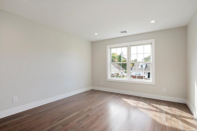 unfurnished room with hardwood / wood-style floors