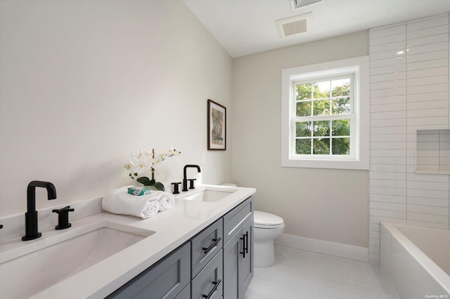 bathroom with tile patterned flooring, vanity, and toilet