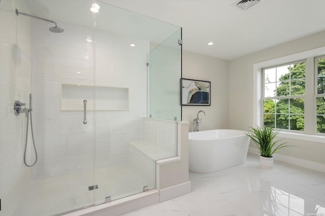 bathroom featuring separate shower and tub