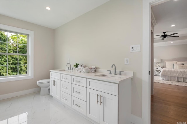 bathroom with vanity, toilet, and ceiling fan