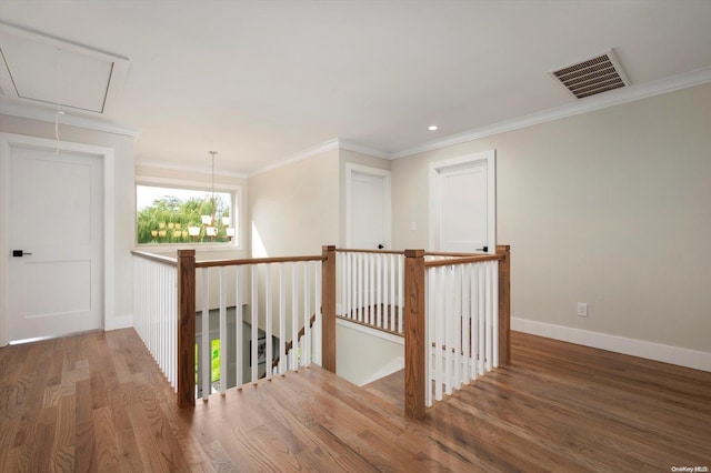 hallway with hardwood / wood-style floors and ornamental molding