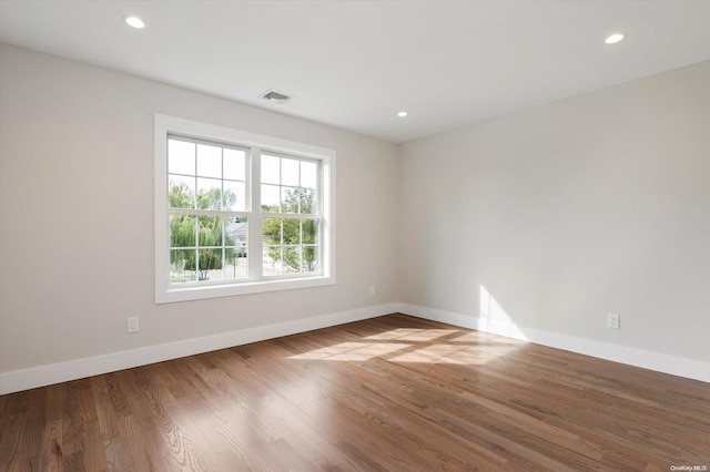 spare room with hardwood / wood-style floors