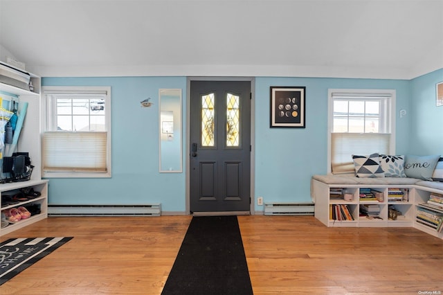 foyer with plenty of natural light, light hardwood / wood-style floors, and a baseboard heating unit