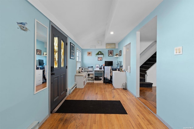 foyer entrance featuring baseboard heating and light hardwood / wood-style flooring