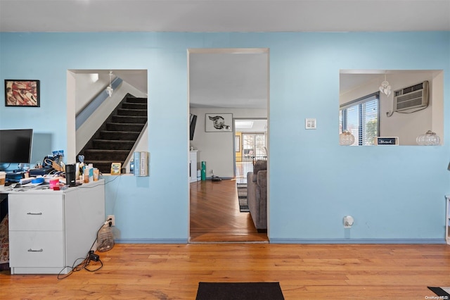 office space featuring a wall mounted AC and light hardwood / wood-style flooring