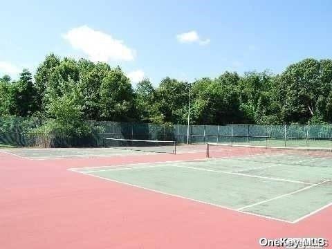 view of sport court featuring basketball hoop