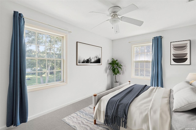 bedroom with carpet flooring, multiple windows, and ceiling fan