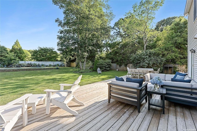 deck with outdoor lounge area and a yard