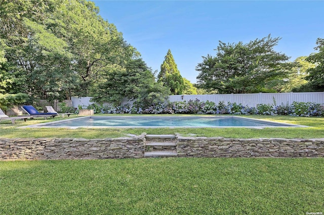 view of swimming pool with a lawn