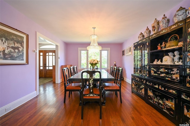 dining room featuring wood-type flooring and a chandelier