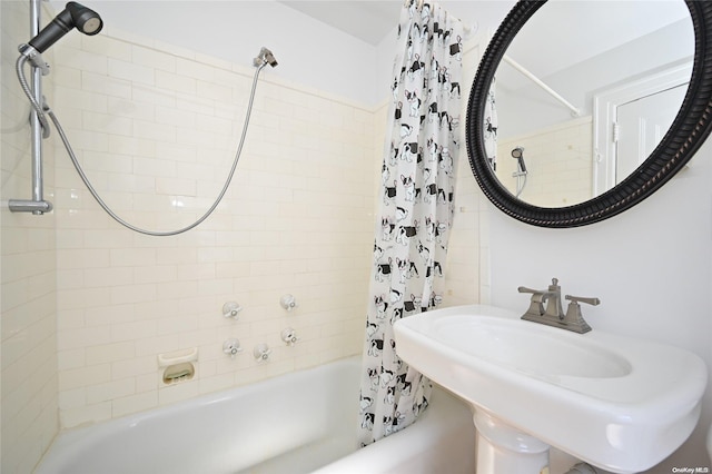 bathroom with shower / tub combo with curtain and sink