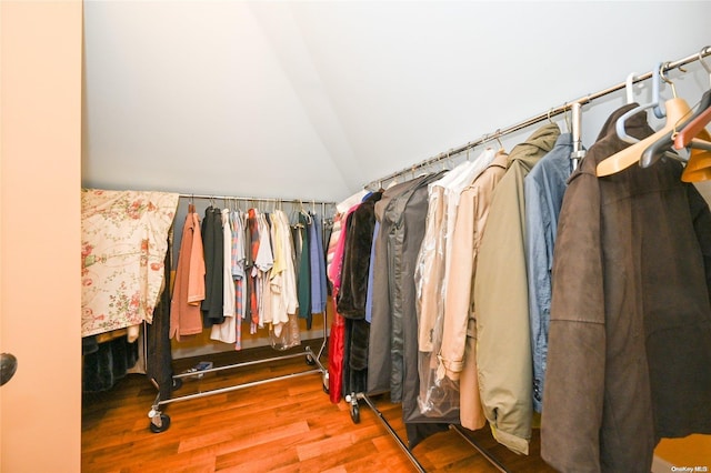 walk in closet featuring hardwood / wood-style flooring and lofted ceiling