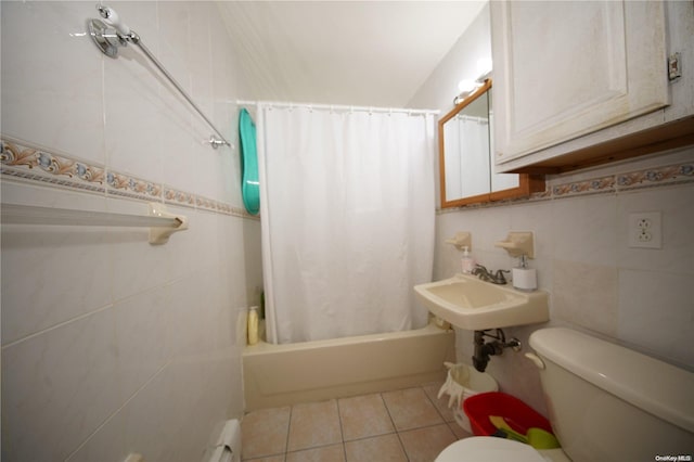 bathroom with tile patterned floors, shower / tub combo, tile walls, and toilet