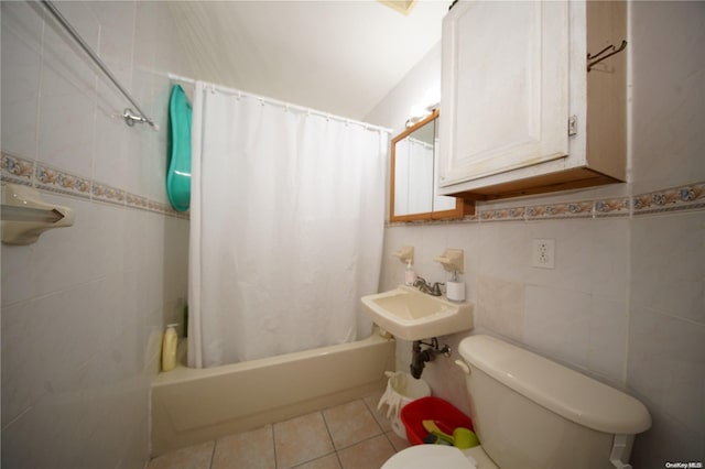 full bathroom featuring shower / bath combo, tile patterned floors, sink, tile walls, and toilet