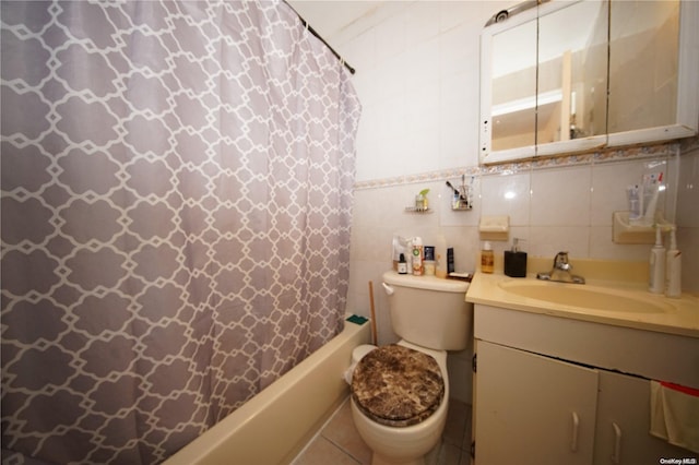 full bathroom with vanity, tile patterned floors, toilet, tile walls, and shower / tub combo