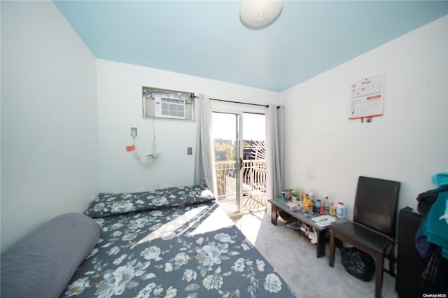 bedroom with a wall unit AC, carpet floors, and access to outside