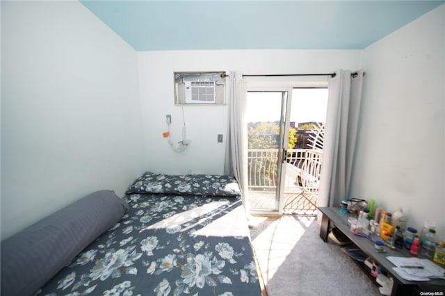 bedroom featuring a wall mounted air conditioner, carpet, and access to outside