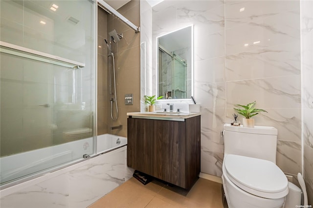 full bathroom featuring vanity, toilet, and enclosed tub / shower combo