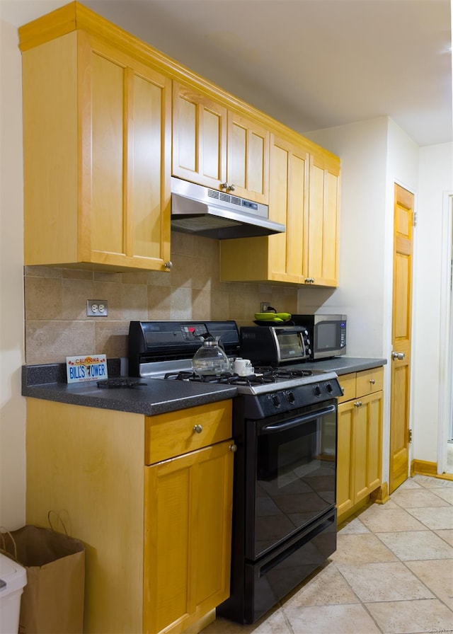 kitchen featuring black gas range oven, light brown cabinets, tasteful backsplash, and light tile patterned floors