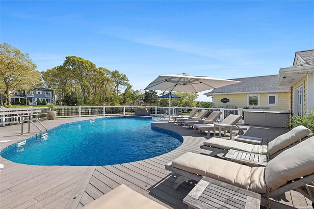 view of swimming pool with a wooden deck